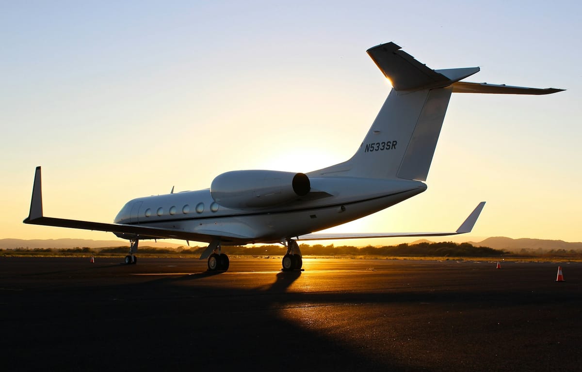 A private jet on the apron at dusk